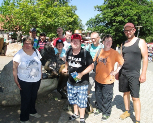 Vor der Bronzeskulptur einer Hexe haben sich die Urlauber zum Gruppenbild aufgestellt.